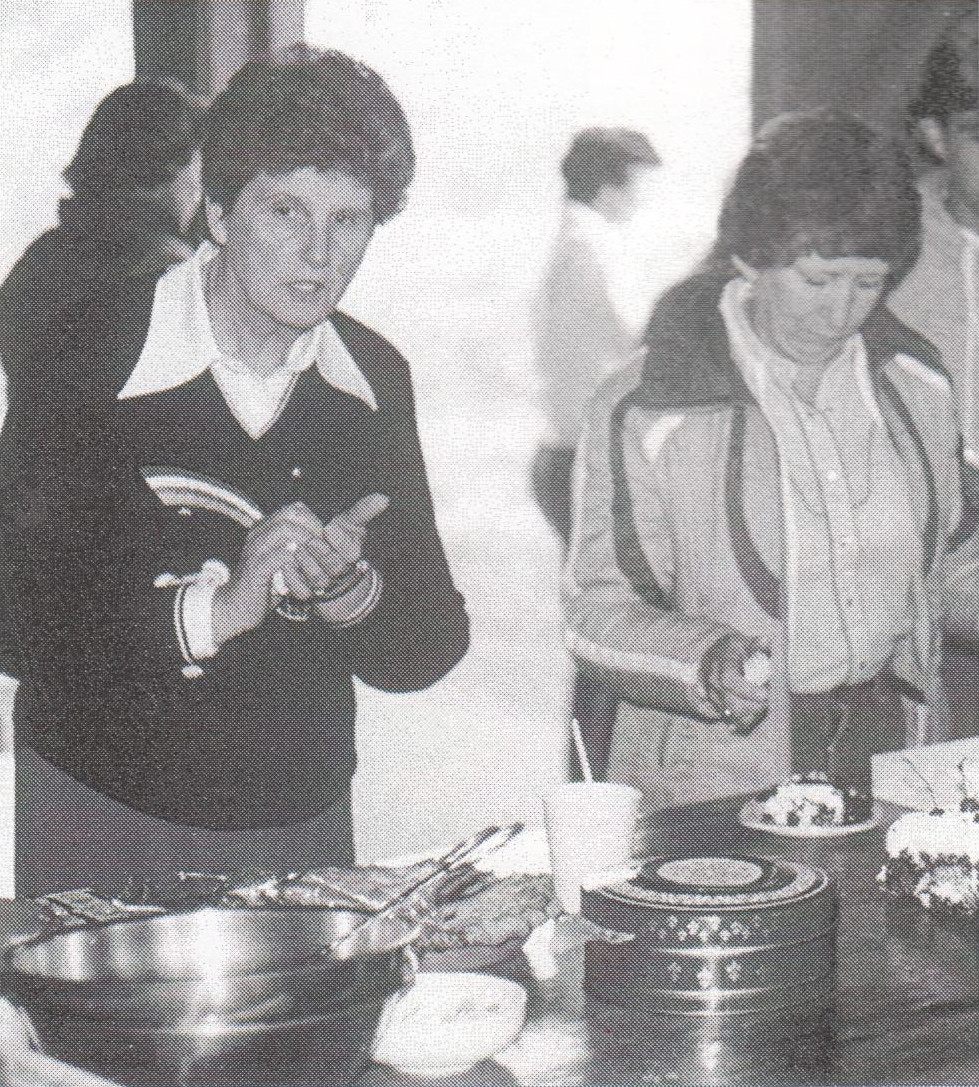 Jean Blackwell serving up pie for Gladys Lemmon at an All Saints campout.