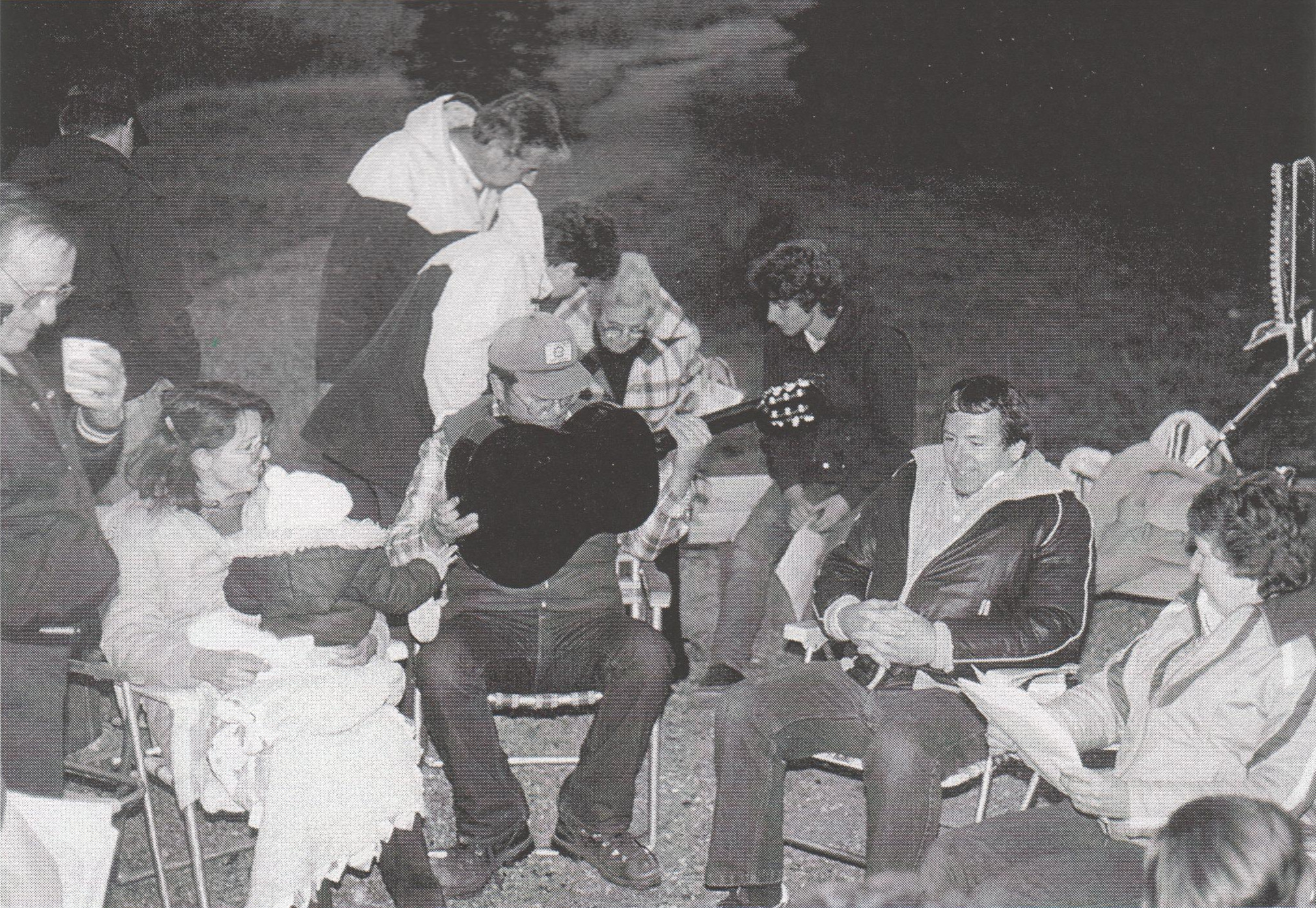In 1985, David McGraw seems to have dropped his pick into the guitar. Surrounding him are Leigh Blackwell with a coffee in hand, Sharon McGraw with an unidentified baby, Peter Hunziker and Jean Blackwell helping Mrs. Hill sit down beside Mark Ashton, and Richard and Gladys Lemmon getting ready to sing.